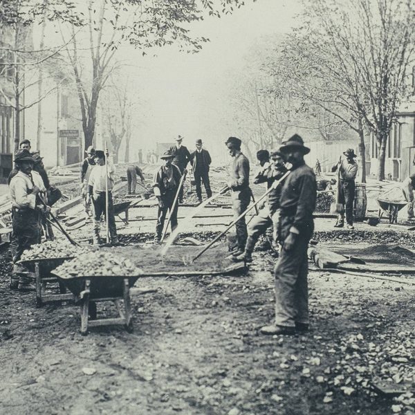 Crews preparing a city street for its first concrete paving (1920s)